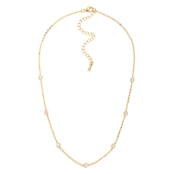 Dainty Crystal Station Necklace with tiny sparkling crystals set along a fine, delicate chain. The barely there design layers effortlessly with pendants and chokers or shines alone for a clean, minimal look. A lobster clasp and extender chain allow an adjustable fit. An everyday essential at an easy price point, perfect for bridesmaid gifts, birthdays, and customers building a layered necklace stack.