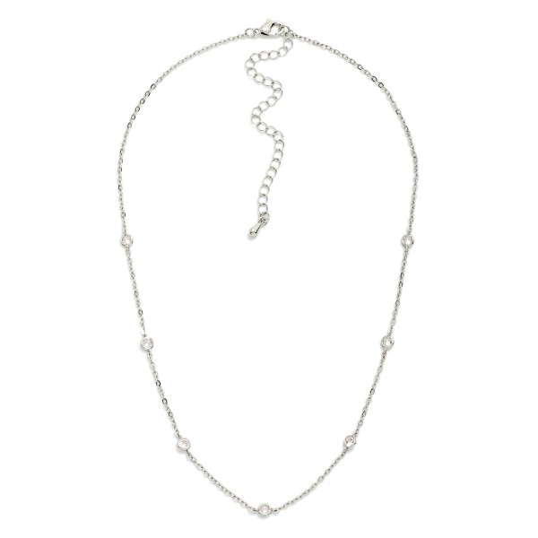 Dainty Crystal Station Necklace with tiny sparkling crystals set along a fine, delicate chain. The barely there design layers effortlessly with pendants and chokers or shines alone for a clean, minimal look. A lobster clasp and extender chain allow an adjustable fit. An everyday essential at an easy price point, perfect for bridesmaid gifts, birthdays, and customers building a layered necklace stack.