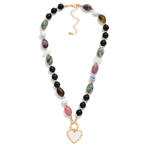 Beaded Heart Pendant Necklace featuring a mix of polished stone look oval beads, glossy round beads, and faux pearls that lead to a framed enamel heart charm. The eclectic bead mix gives it a collected, boho feel while the heart keeps it sweet and wearable. Finished with a lobster clasp and extender chain. Great for gifting, Valentine's displays, and customers who love a bold necklace that still feels personal.