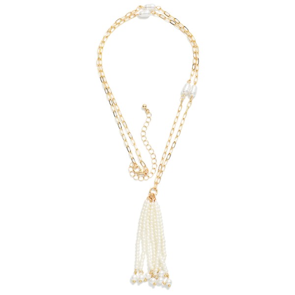 Pearl Tassel Layered Necklace featuring two delicate chain strands accented with pearl stations and finished with a cascading faux pearl tassel pendant. The layered look is built in, so customers get a polished stacked style from one piece. Lightweight with a lobster clasp and extender chain for an easy, adjustable fit. A soft, feminine statement that pairs beautifully with sweaters, blouses, and holiday dresses.