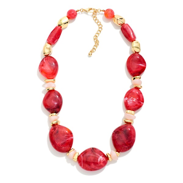 Chunky Resin Statement Necklace featuring graduated organic shaped beads with a glossy marbled finish, separated by faceted spacers and polished metal accents. Larger stones at the center create a bold focal point that elevates a plain tee, a cozy sweater, or a simple dress. Lightweight resin keeps it comfortable despite the bold scale, and an adjustable chain fits most necklines. Statement necklaces are a top add on sale, giving shoppers a quick outfit upgrade at a boutique friendly price.