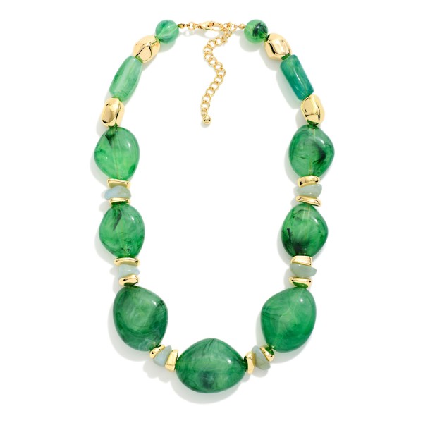 Chunky Resin Statement Necklace featuring graduated organic shaped beads with a glossy marbled finish, separated by faceted spacers and polished metal accents. Larger stones at the center create a bold focal point that elevates a plain tee, a cozy sweater, or a simple dress. Lightweight resin keeps it comfortable despite the bold scale, and an adjustable chain fits most necklines. Statement necklaces are a top add on sale, giving shoppers a quick outfit upgrade at a boutique friendly price.