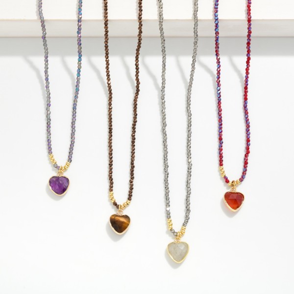 Seed Bead Heart Pendant Necklace with a twisted strand of tiny glass seed beads finished by a faceted heart pendant in a polished bezel. The slim, textured strand adds dimension while staying light enough for everyday wear. Lovely layered with dainty chains or worn alone with tees, knits, and casual dresses. A sweet, giftable style that works for Valentine gifts, birthdays, and everyday treats, so it sells all year.