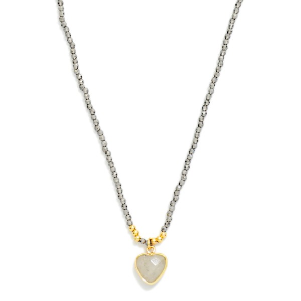 Seed Bead Heart Pendant Necklace with a twisted strand of tiny glass seed beads finished by a faceted heart pendant in a polished bezel. The slim, textured strand adds dimension while staying light enough for everyday wear. Lovely layered with dainty chains or worn alone with tees, knits, and casual dresses. A sweet, giftable style that works for Valentine gifts, birthdays, and everyday treats, so it sells all year.