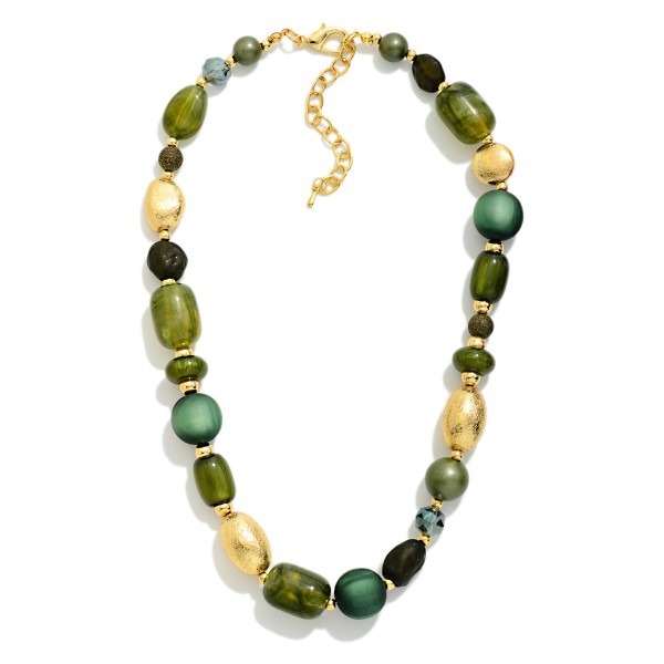 Chunky Mixed Bead Necklace layering glossy and matte beads in varied shapes with textured metal accent beads. The graduated, collar length design makes a bold statement on its own or styled over turtlenecks and button downs. A lobster clasp and extender chain allow an easy, adjustable fit. Earthy, oversized necklaces are a fall favorite that give boutiques an easy, outfit completing upsell.