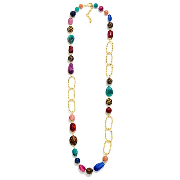 Long Beaded Chain Link Necklace that pairs a strand of mixed stone look beads with oversized twisted oval links for an asymmetric, modern design. The extra length slips easily over the head and layers beautifully with shorter pieces. Wear it with sweaters, tunics, and fall dresses for an instant finishing touch. Long statement necklaces like this are a boutique staple that customers rebuy season after season.