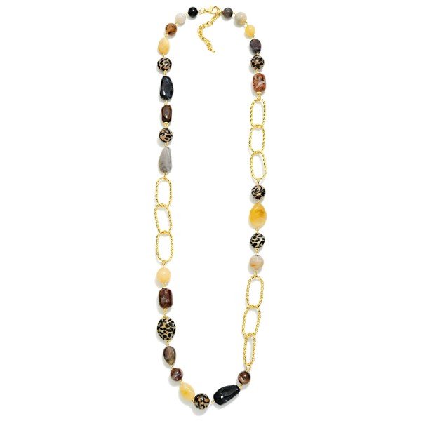 Long Beaded Chain Link Necklace that pairs a strand of mixed stone look beads with oversized twisted oval links for an asymmetric, modern design. The extra length slips easily over the head and layers beautifully with shorter pieces. Wear it with sweaters, tunics, and fall dresses for an instant finishing touch. Long statement necklaces like this are a boutique staple that customers rebuy season after season.