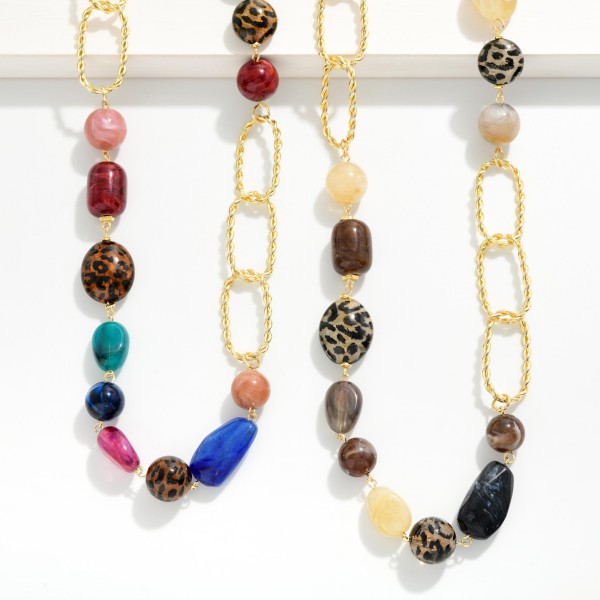 Long Beaded Chain Link Necklace that pairs a strand of mixed stone look beads with oversized twisted oval links for an asymmetric, modern design. The extra length slips easily over the head and layers beautifully with shorter pieces. Wear it with sweaters, tunics, and fall dresses for an instant finishing touch. Long statement necklaces like this are a boutique staple that customers rebuy season after season.