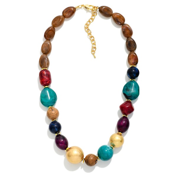 Mixed Bead Statement Necklace combining smooth nuggets, faceted glass, and polished metal beads in a graduated design. The varied shapes and textures give it a collected, artisan feel that elevates basic tees and knits. Finished with a lobster clasp and extender chain for an adjustable fit. A rich fall layering piece that boutiques can style with sweaters and jackets for an easy add on sale.