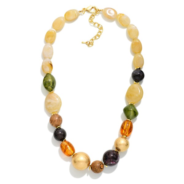 Mixed Bead Statement Necklace combining smooth nuggets, faceted glass, and polished metal beads in a graduated design. The varied shapes and textures give it a collected, artisan feel that elevates basic tees and knits. Finished with a lobster clasp and extender chain for an adjustable fit. A rich fall layering piece that boutiques can style with sweaters and jackets for an easy add on sale.