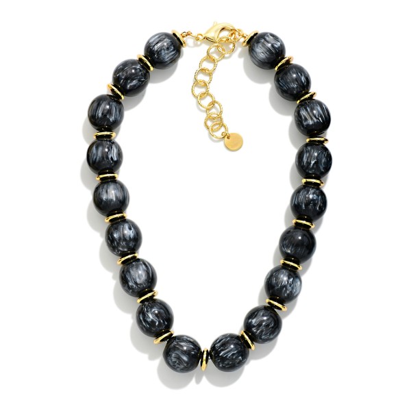 Chunky Marbled Bead Necklace featuring oversized round beads with a swirled, glossy finish separated by polished metal spacers. The bold, collar length silhouette finishes simple outfits instantly and pairs well with sweaters, blouses, and dresses. A lobster clasp with an extender chain allows an easy, adjustable fit. A true statement necklace at an approachable price that boutique shoppers love to style for fall and the holidays.