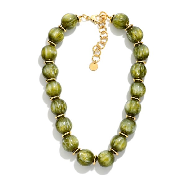 Chunky Marbled Bead Necklace featuring oversized round beads with a swirled, glossy finish separated by polished metal spacers. The bold, collar length silhouette finishes simple outfits instantly and pairs well with sweaters, blouses, and dresses. A lobster clasp with an extender chain allows an easy, adjustable fit. A true statement necklace at an approachable price that boutique shoppers love to style for fall and the holidays.