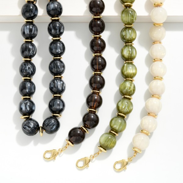 Chunky Marbled Bead Necklace featuring oversized round beads with a swirled, glossy finish separated by polished metal spacers. The bold, collar length silhouette finishes simple outfits instantly and pairs well with sweaters, blouses, and dresses. A lobster clasp with an extender chain allows an easy, adjustable fit. A true statement necklace at an approachable price that boutique shoppers love to style for fall and the holidays.