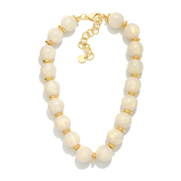 Chunky Marbled Bead Necklace featuring oversized round beads with a swirled, glossy finish separated by polished metal spacers. The bold, collar length silhouette finishes simple outfits instantly and pairs well with sweaters, blouses, and dresses. A lobster clasp with an extender chain allows an easy, adjustable fit. A true statement necklace at an approachable price that boutique shoppers love to style for fall and the holidays.