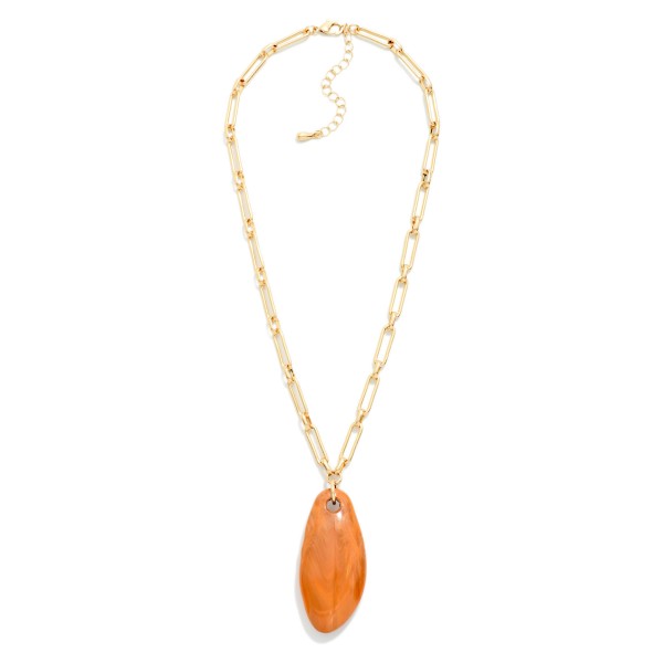 Organic Drop Pendant Necklace with a smooth, polished pendant suspended from an elongated paperclip style chain. The rounded, natural looking shape adds warmth and texture to simple outfits. Great for layering with dainty chains or wearing solo over tees, knits, and fall dresses. An easy, earthy statement that fits boho and modern boutiques alike and sells well into the holiday season.