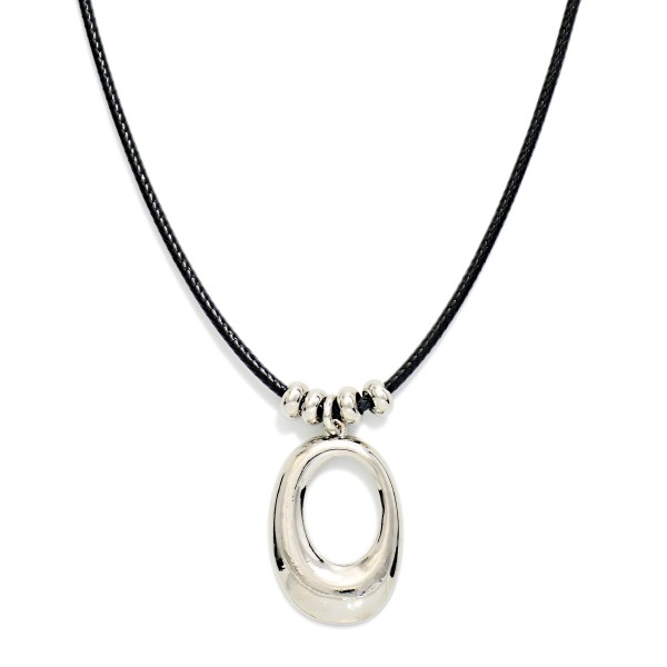 Sculpted Oval Pendant Necklace on a soft cord with sliding metal bead accents above a polished open oval pendant. The cord length makes it easy to wear high on the neck or lower over a sweater. A modern everyday piece for work, weekend outfits, and layering with fine chains. Clean, minimalist styles like this appeal to a wide range of customers and sell steadily all year.