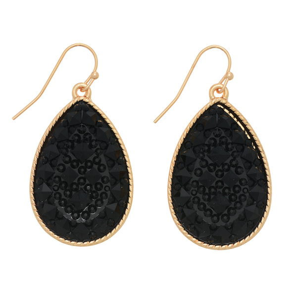 Gold tone fishhook earrings featuring a black textured teardrop shaped stone. Approximately 1 1/4" in length.