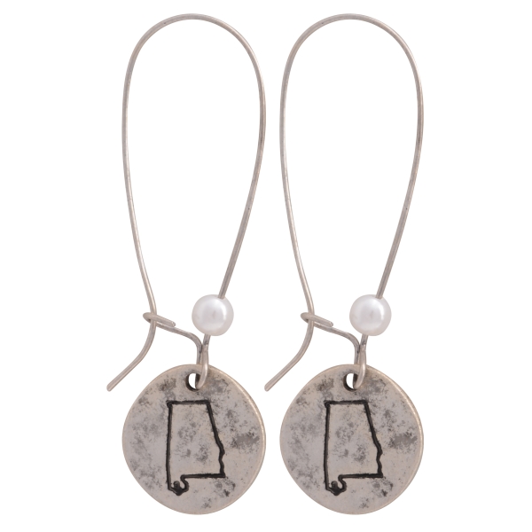 Burnished silver tone fishhook earrings featuring a disk stamped with the state of Alabama and a faux pearl accent. Approximately 1 1/2" in length.
