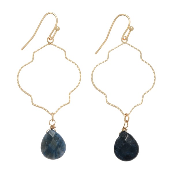 Gold tone fishhook earrings featuring a thin textured open organic shape with a teardrop shaped sodalite stone. Approximately 1 1/8" in length.