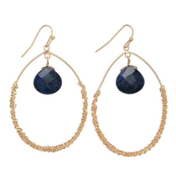 Gold tone fishhook earrings featuring an open teardrop shape with a sodalite hanging natural stone. Approximately 2" in length.