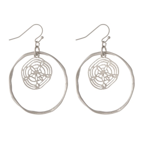 Silver tone fishhook earrings with a hammered circle and a sand dollar. Approximately 1.25" in diameter. 
