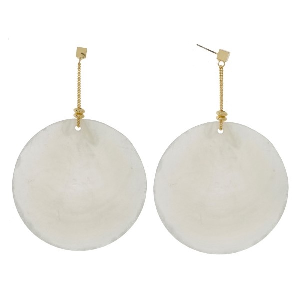 Gold tone post earrings with a large, circle, shell focal. Approximately 4" in length. 