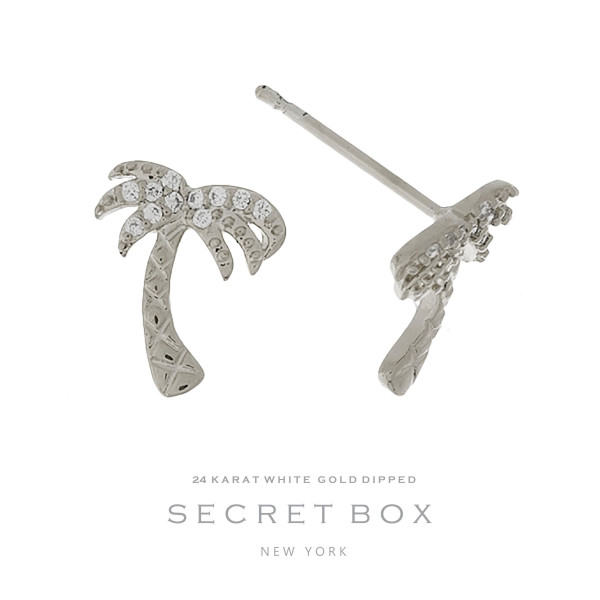 Secret Box 24 karat white gold dipped over brass palm tree stud earrings. Approximately 1/2" in length. Sold in a gift box.