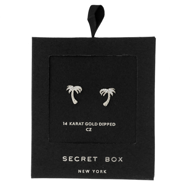 Secret Box 24 karat white gold dipped over brass palm tree stud earrings. Approximately 1/2" in length. Sold in a gift box.