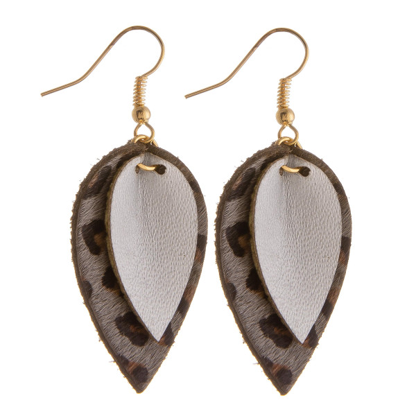 Genuine leather drop earrings featuring animal print and gold details. Approximately 1.5" in length. 