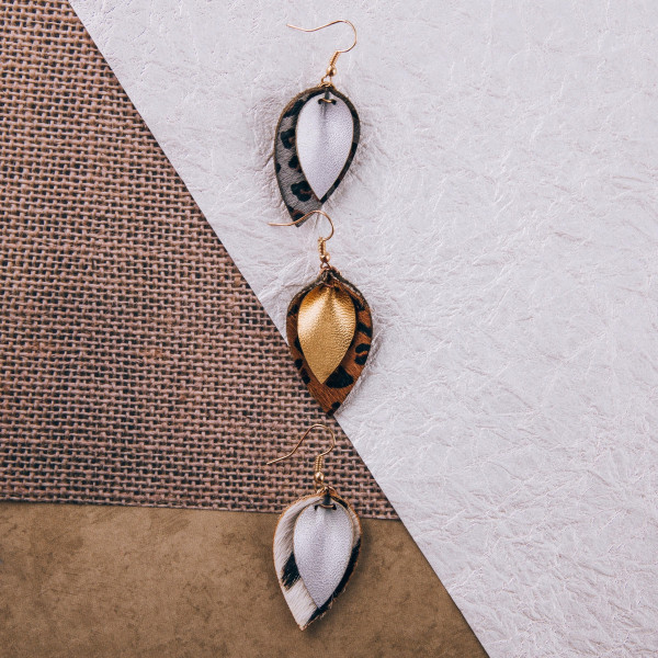 Genuine leather drop earrings featuring animal print and gold details. Approximately 1.5" in length. 
