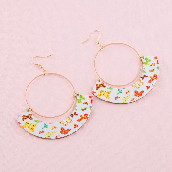 Large circular drop earrings featuring a wood inspired accent with butterfly details. Approximately 3" in length.