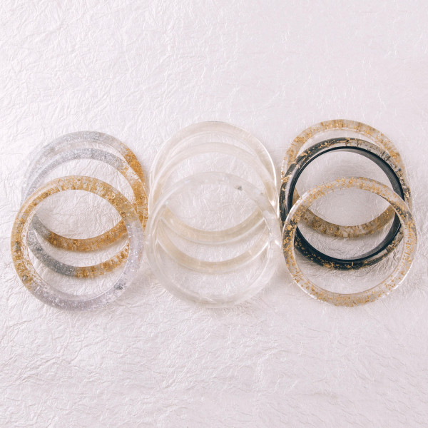 Bracelet set featuring three resin inspired bracelets with iridescent accents. Approximately 3" in diameter. Fits up to a 6" wrist.