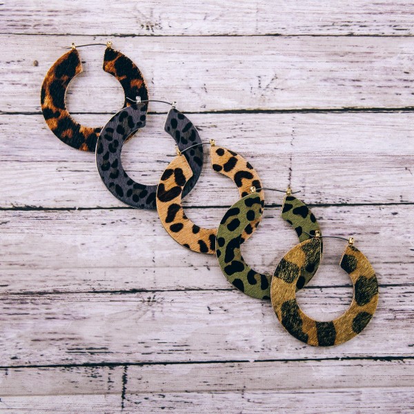Leopard print cowhide flat pin catch hoop earrings. 

- Approximately 2" in diameter