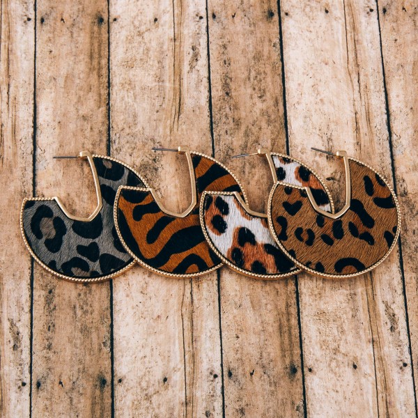 Cowhide leopard print encased open hoop disc earrings.

- Approximately 2" in diameter
