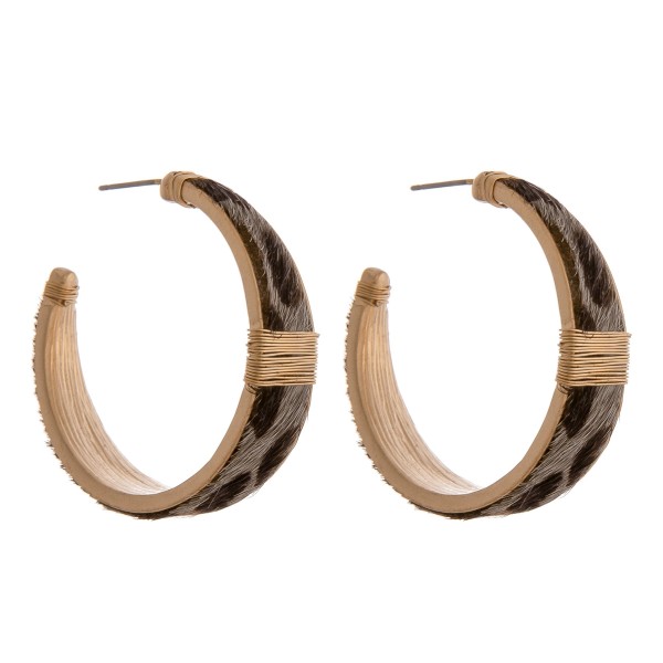 Cowhide leopard print hoop earrings with wire wrapped details.

- Approximately 1.5" in diameter
- Approximately 1cm in width