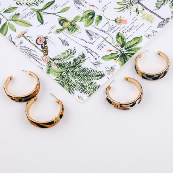 Cowhide leopard print hoop earrings with wire wrapped details.

- Approximately 1.5" in diameter
- Approximately 1cm in width