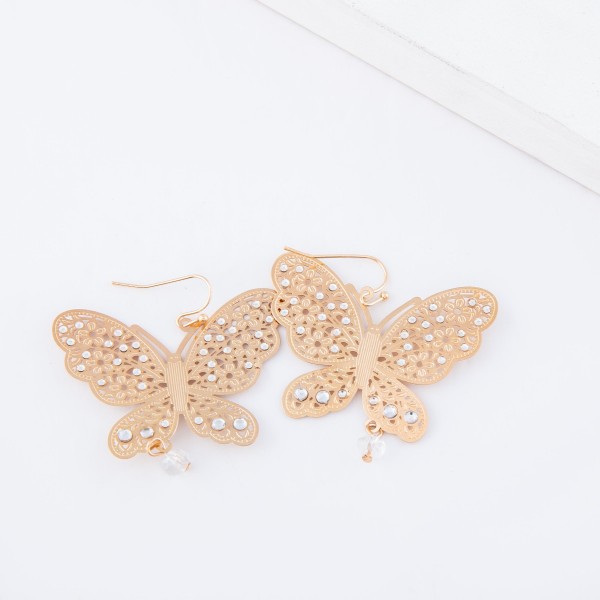 Gold filigree butterfly drop earrings with beaded accents.

- Approximately 2" x 2"