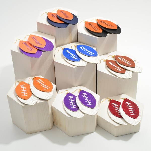 Long Leather Football Earrings Featuring Feathered Accents. 

- Approximately 3.5" in Length