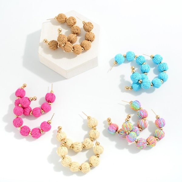 Raffia Bead Drop Hoop Earrings With Gold Tone Accents

- Approximately 2" L