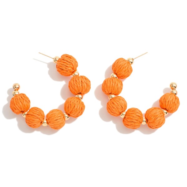 Raffia Bead Drop Hoop Earrings With Gold Tone Accents

- Approximately 2" L