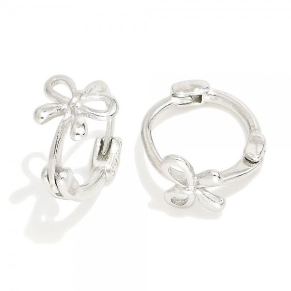 Metal Tone Huggie Hoops With Bow Detail 

- Approximately .5" D 