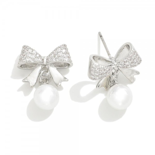 Metal Tone Cubic Zirconia Studded Bow Earrings With Pearl Accent 

- Approximately .75" L 