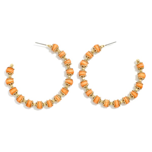 Wood Beaded Hoop Earrings With Gold Tone Details 

- Approximately 2" D