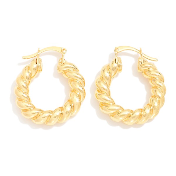 Twisted Metal Tone Hoop Earrings

- Approximately .75" D 
- 18k Gold Filled
- Hypoallergenic
- Made In Brazil