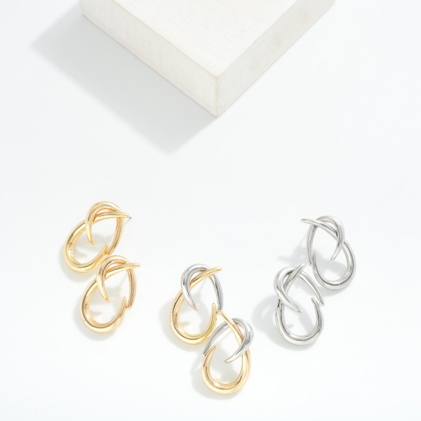 Metal Tone Twisted Hoops With A Modern Sculptural Design 

 - Approximately 1.5" L