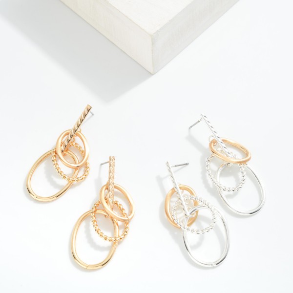 Textured Metal Tone Overlapping Hoops Hanging From A Vertical Bar Stud 

- Approximately 1.50" L

