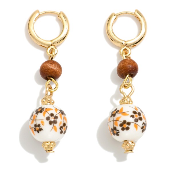 Huggie Hoop Gold Tone Earring Featuring Chinoiserie Flower Bead

- Approximately 1.75" L  


