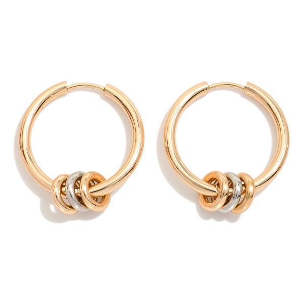 Metal tone Hoop Drop Earring Featuring Metal Tone Disc Charms 

- Approximately 1.5" 