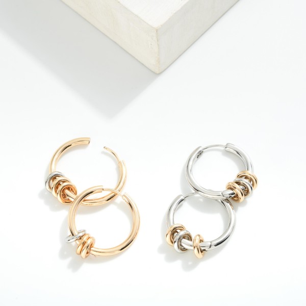 Metal tone Hoop Drop Earring Featuring Metal Tone Disc Charms 

- Approximately 1.5" 