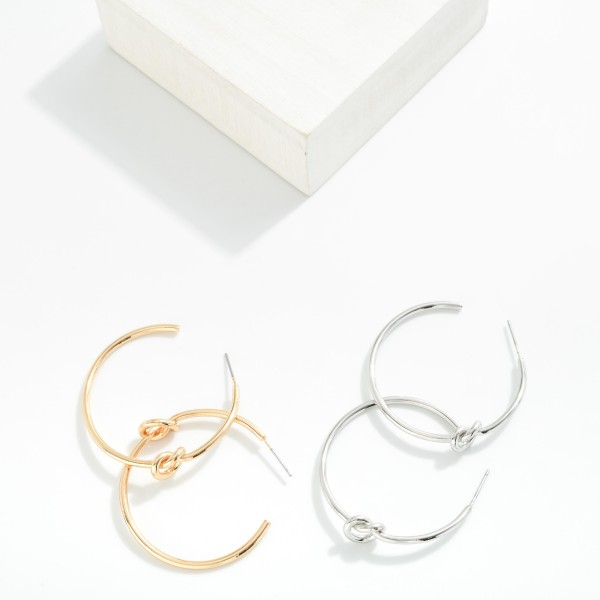 Metal Tone Knotted Hoop Earrings

- Approximately 1.25" D